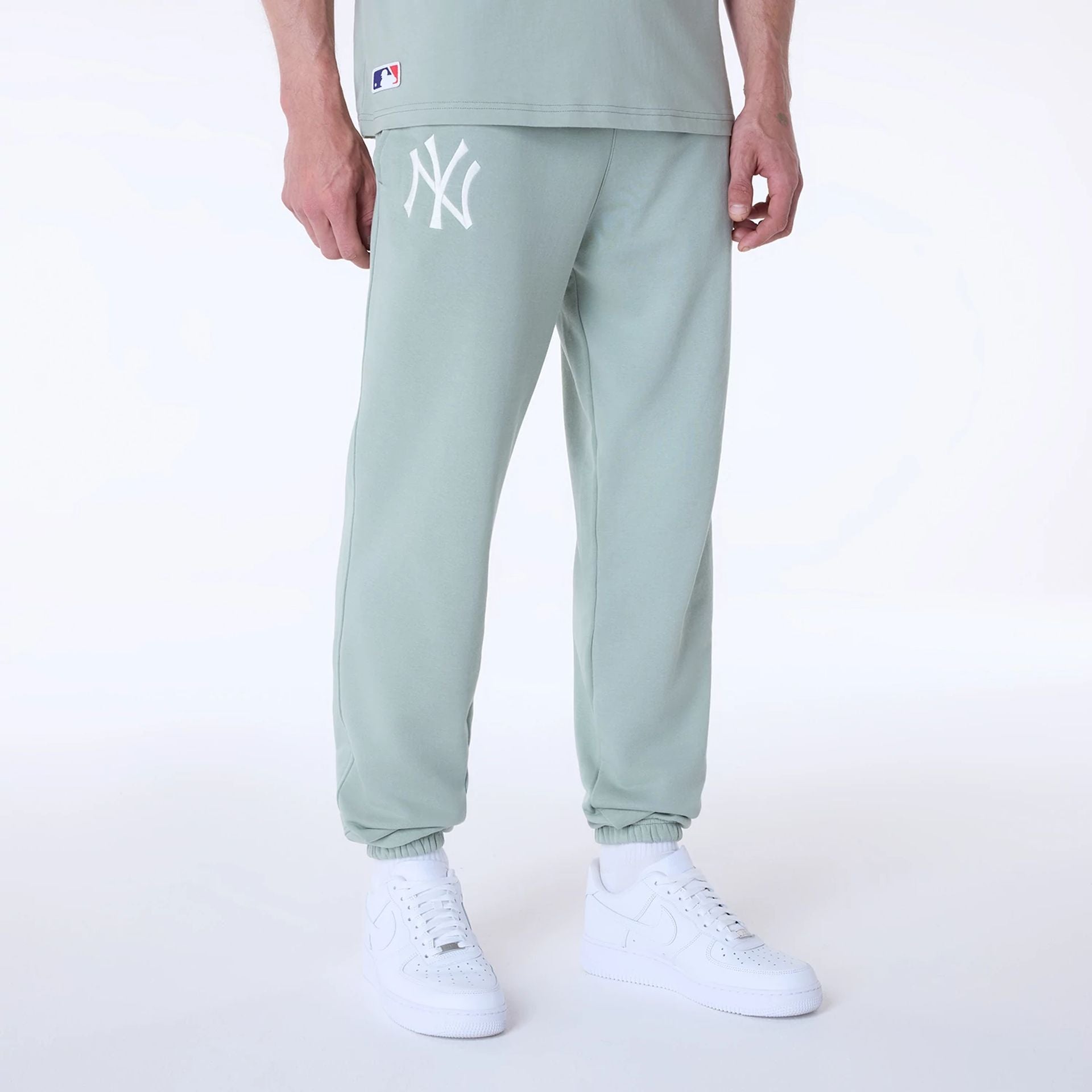 The Male model is wearing New York Yankees MLB League Essential Pastel Green Fleece Joggers 1