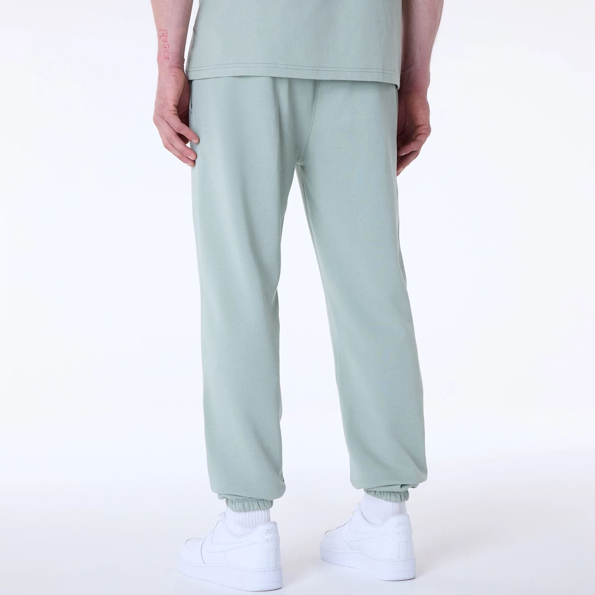 The Male model is wearing New York Yankees MLB League Essential Pastel Green Fleece Joggers 2