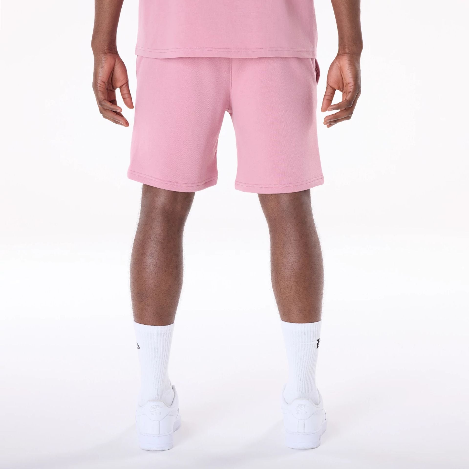 The Male model is wearing New York Yankees MLB League Essential Dark Pink Shorts 2