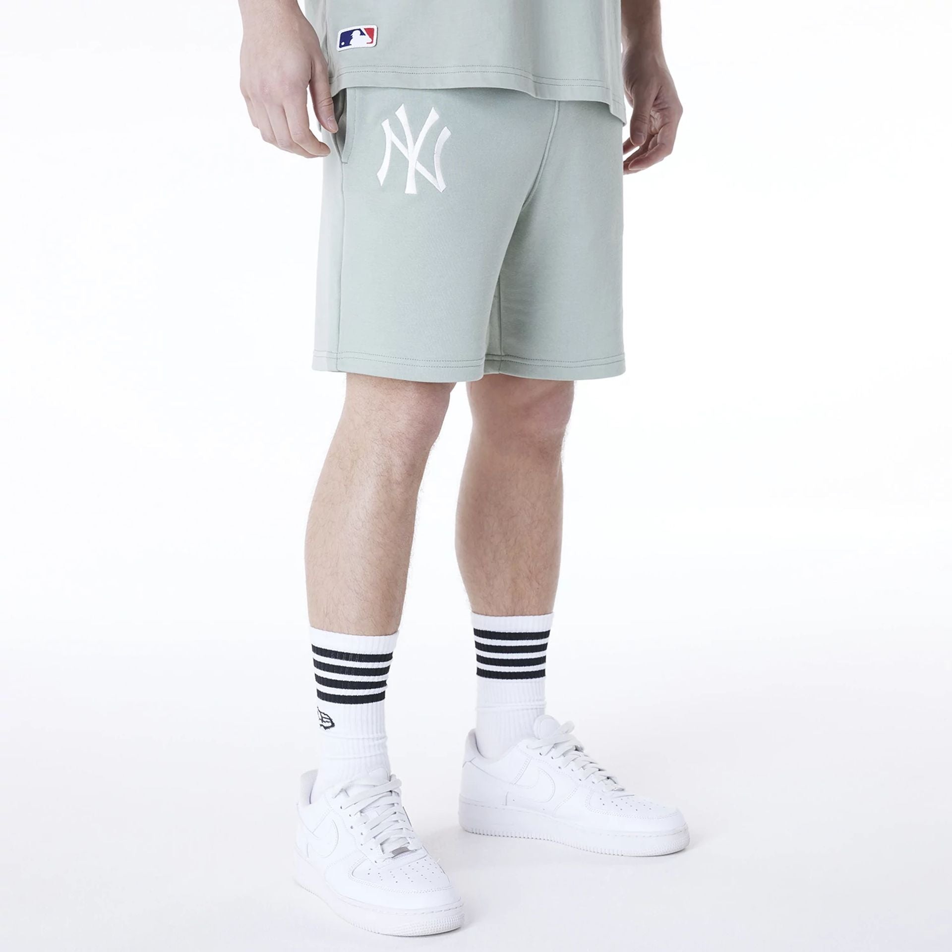 The Male model is wearing New York Yankees MLB League Essential Pastel Green Shorts 1