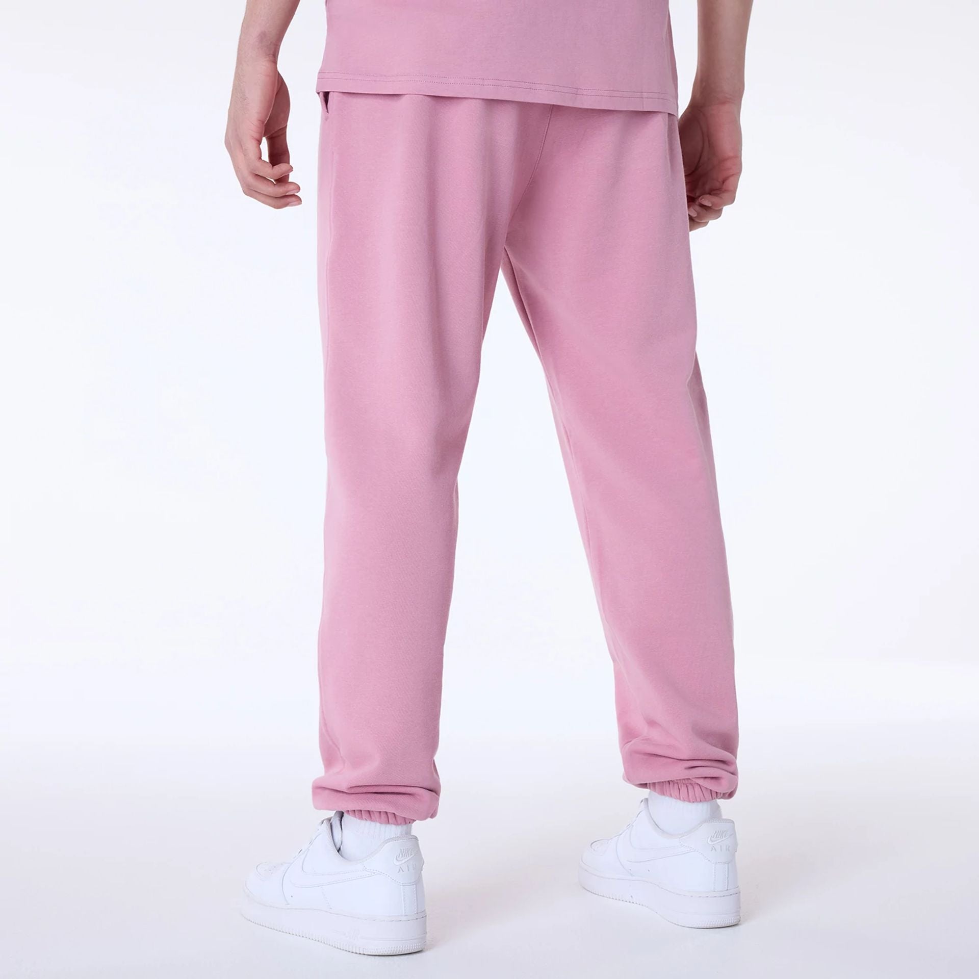 The Male model is wearing New York Yankees MLB League Essential Dark Pink Fleece Joggers 2