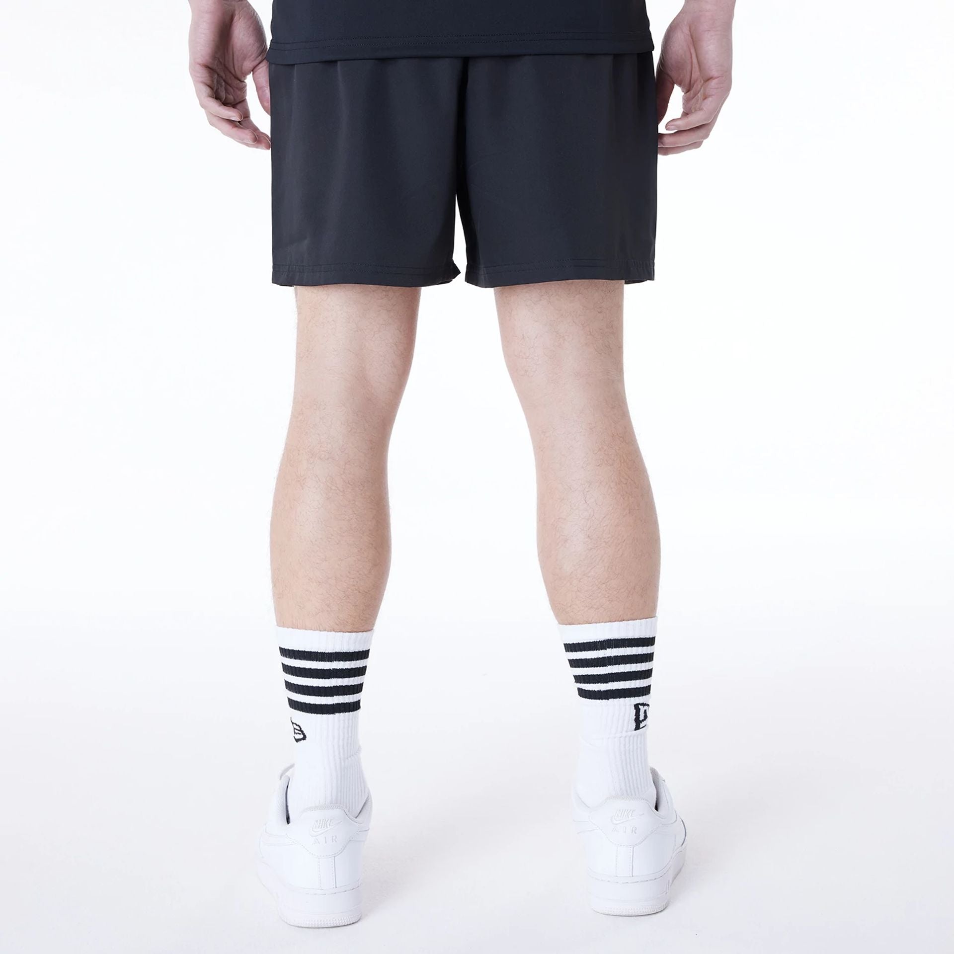 The Male model is wearing New Era Essential Black Shorts 6