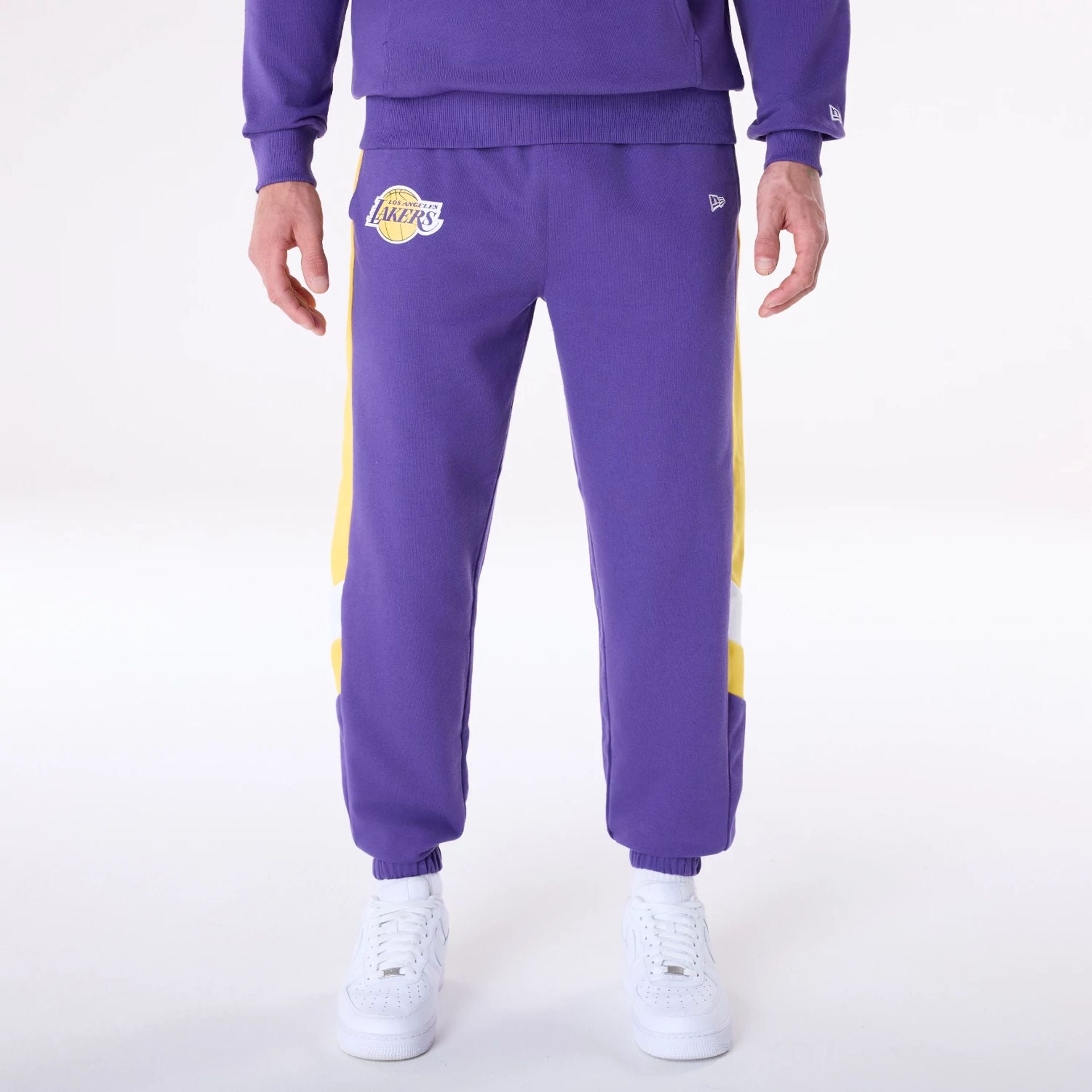 The Male model is wearing LA Lakers NBA Panel Purple Fleece Joggers 1