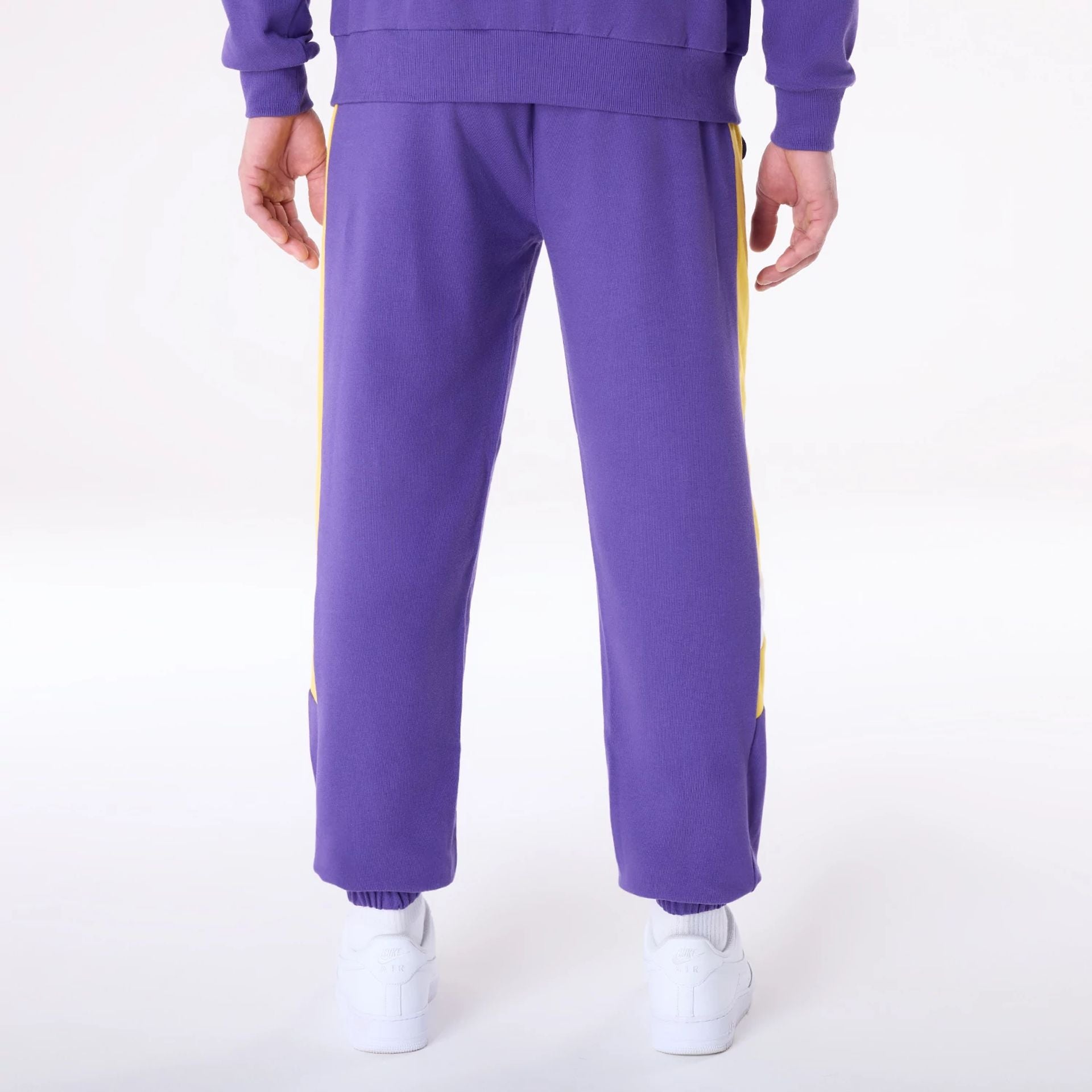 The Male model is wearing LA Lakers NBA Panel Purple Fleece Joggers 2