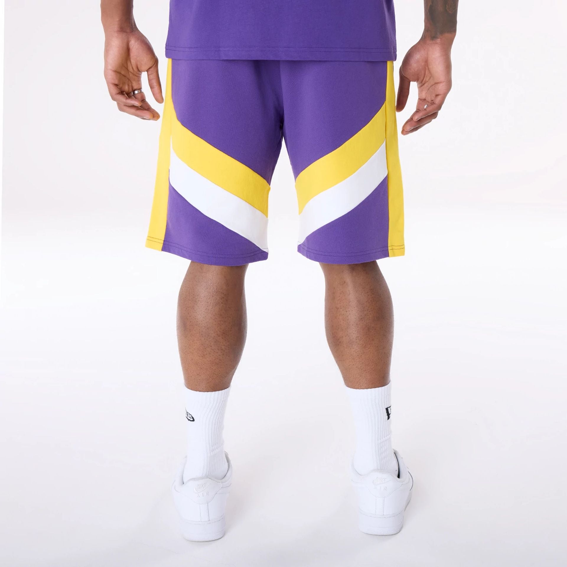 The Male model is wearing LA Lakers NBA Panel Purple Shorts 2