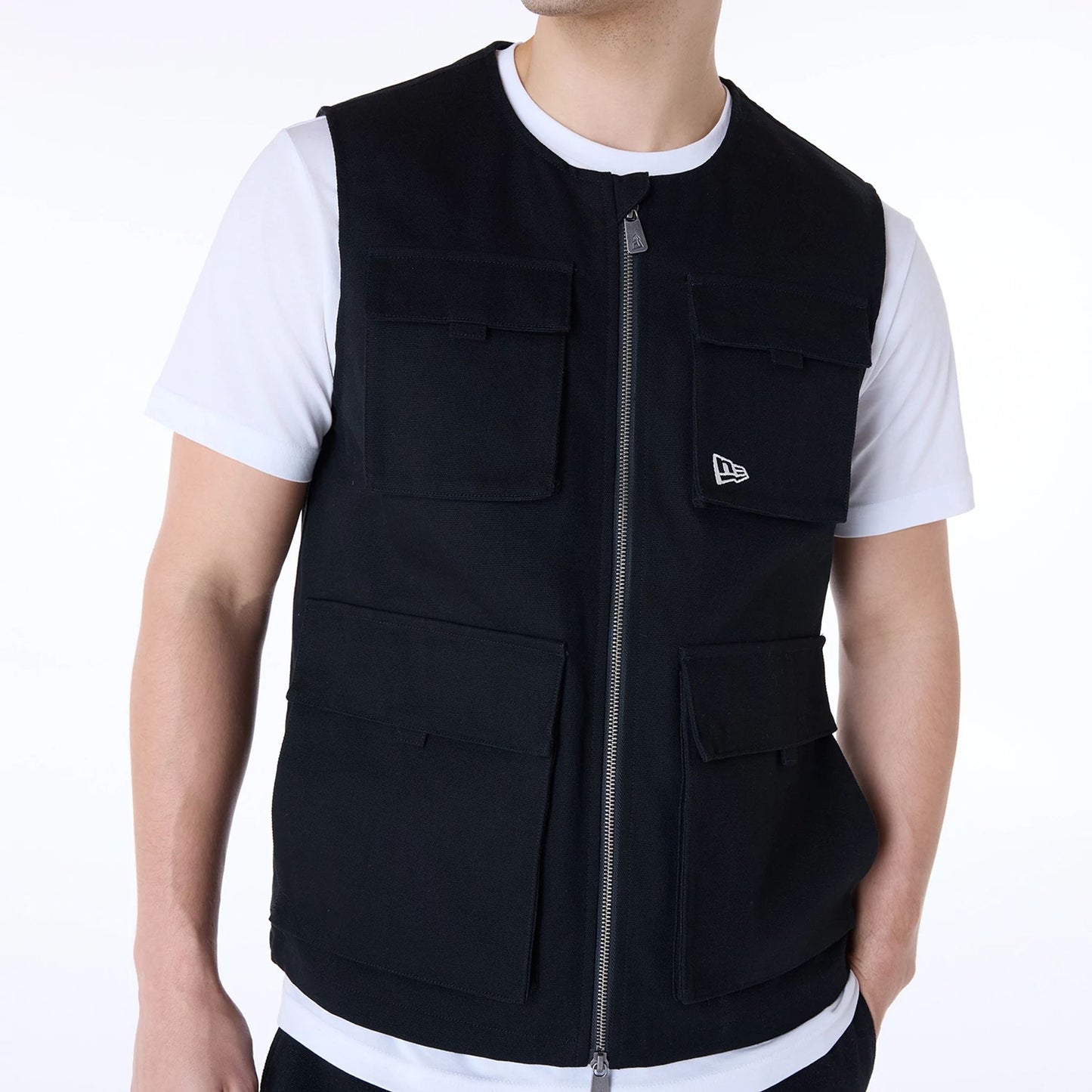 The Male model is wearing New Era Essential Black Utility Vest 6