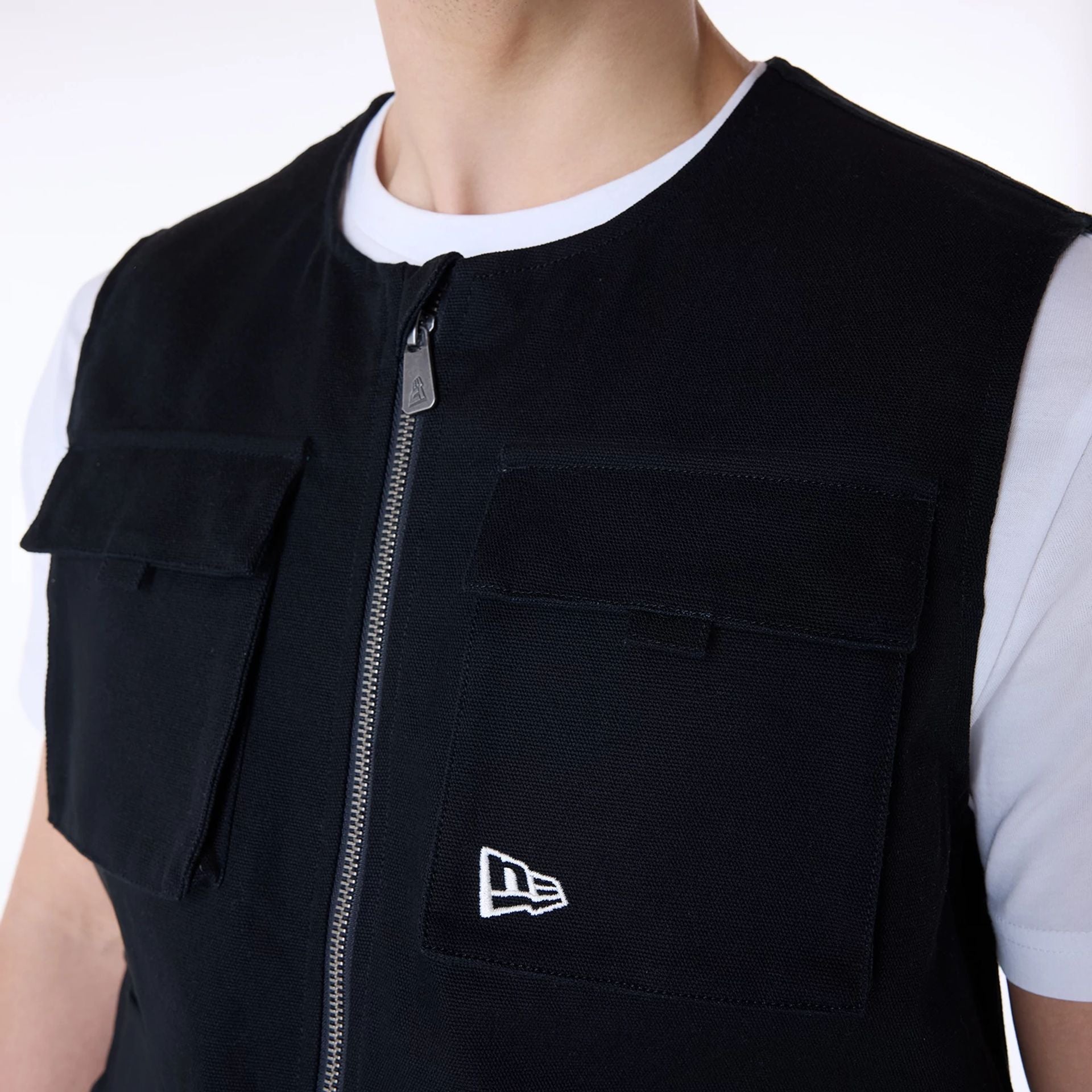 The Male model is wearing New Era Essential Black Utility Vest 8