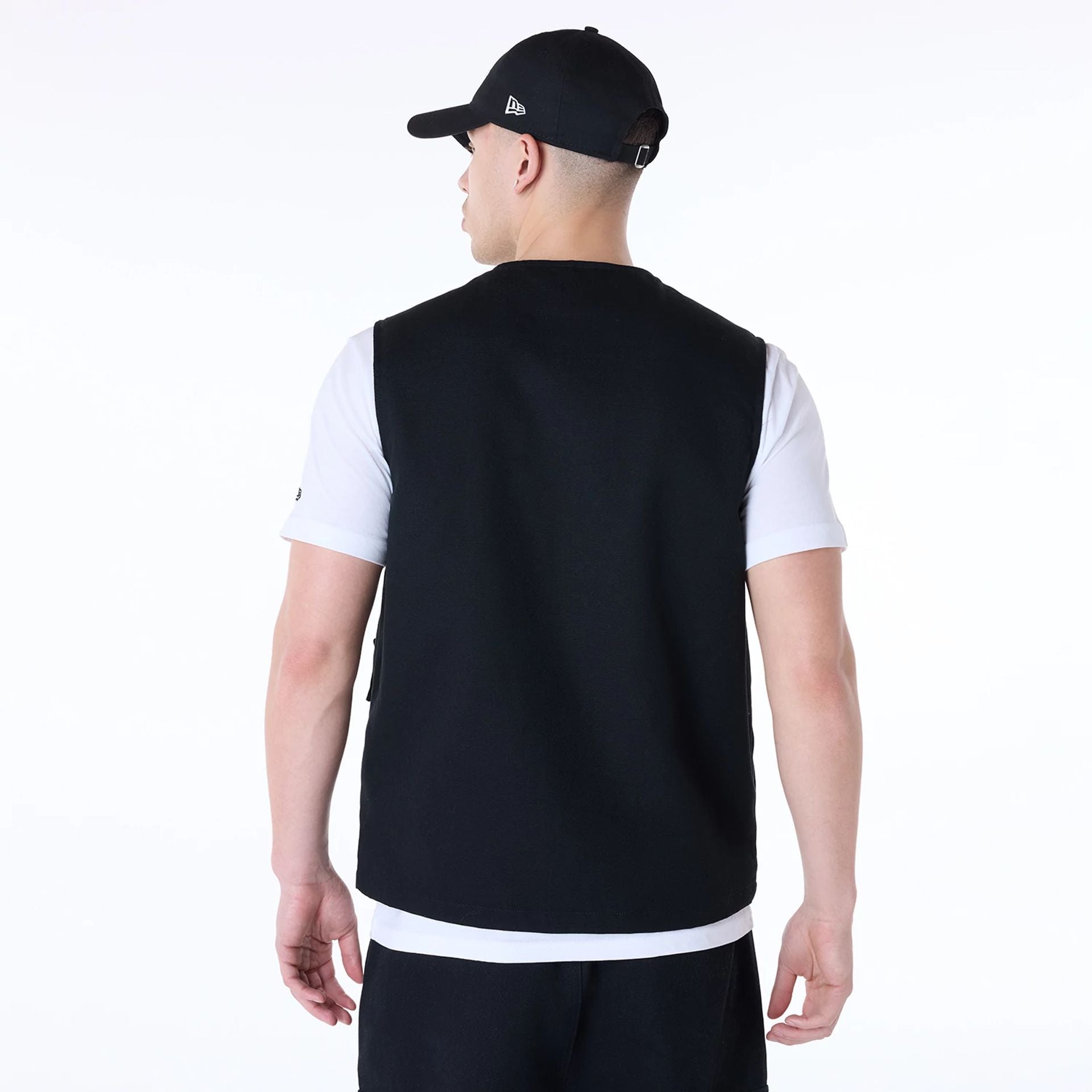 The Male model is wearing New Era Essential Black Utility Vest 2