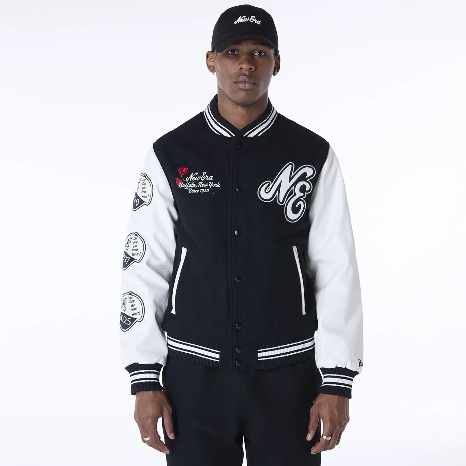 The Male model is wearing New Era Essential Black Varsity Jacket 1