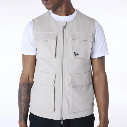 The Male model is wearing New Era Essential Cream Utility Vest 6