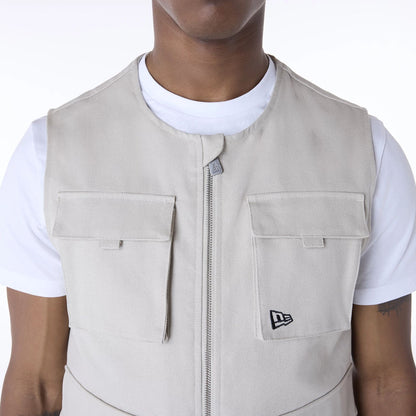 The Male model is wearing New Era Essential Cream Utility Vest 4