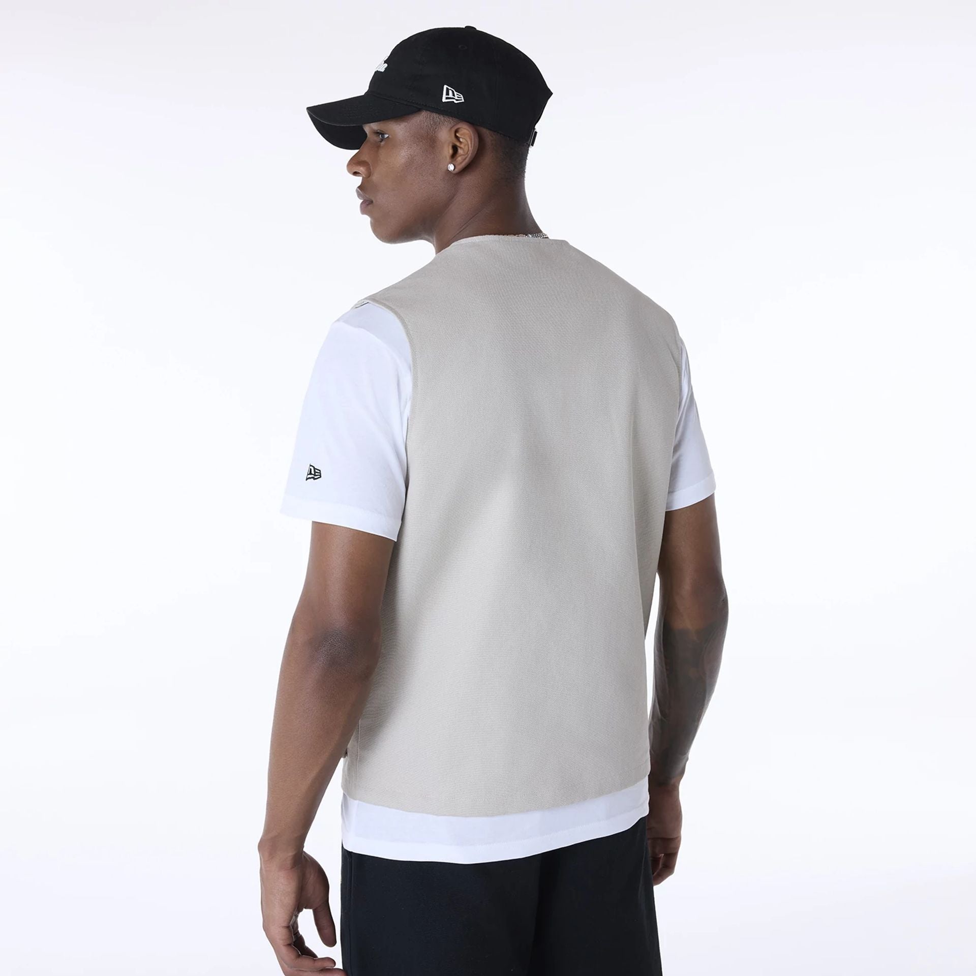 The Male model is wearing New Era Essential Cream Utility Vest 7