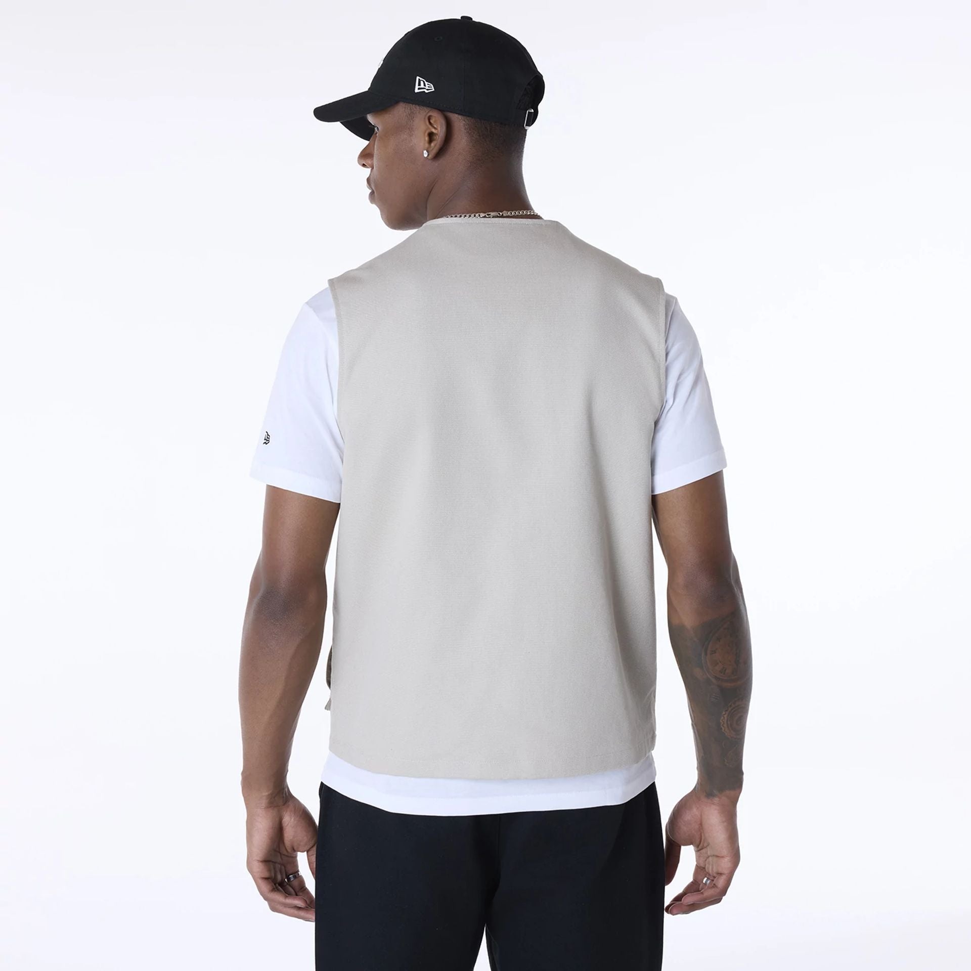 The Male model is wearing New Era Essential Cream Utility Vest 2