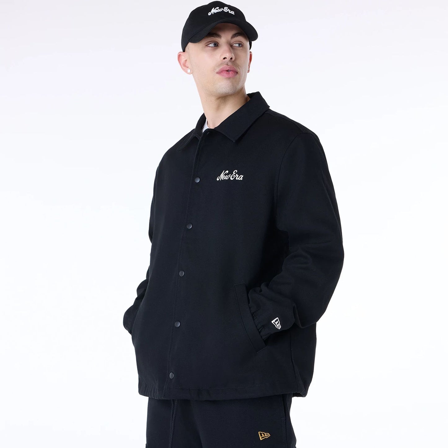 The Male model is wearing New Era Essential Black Coaches Jacket 3