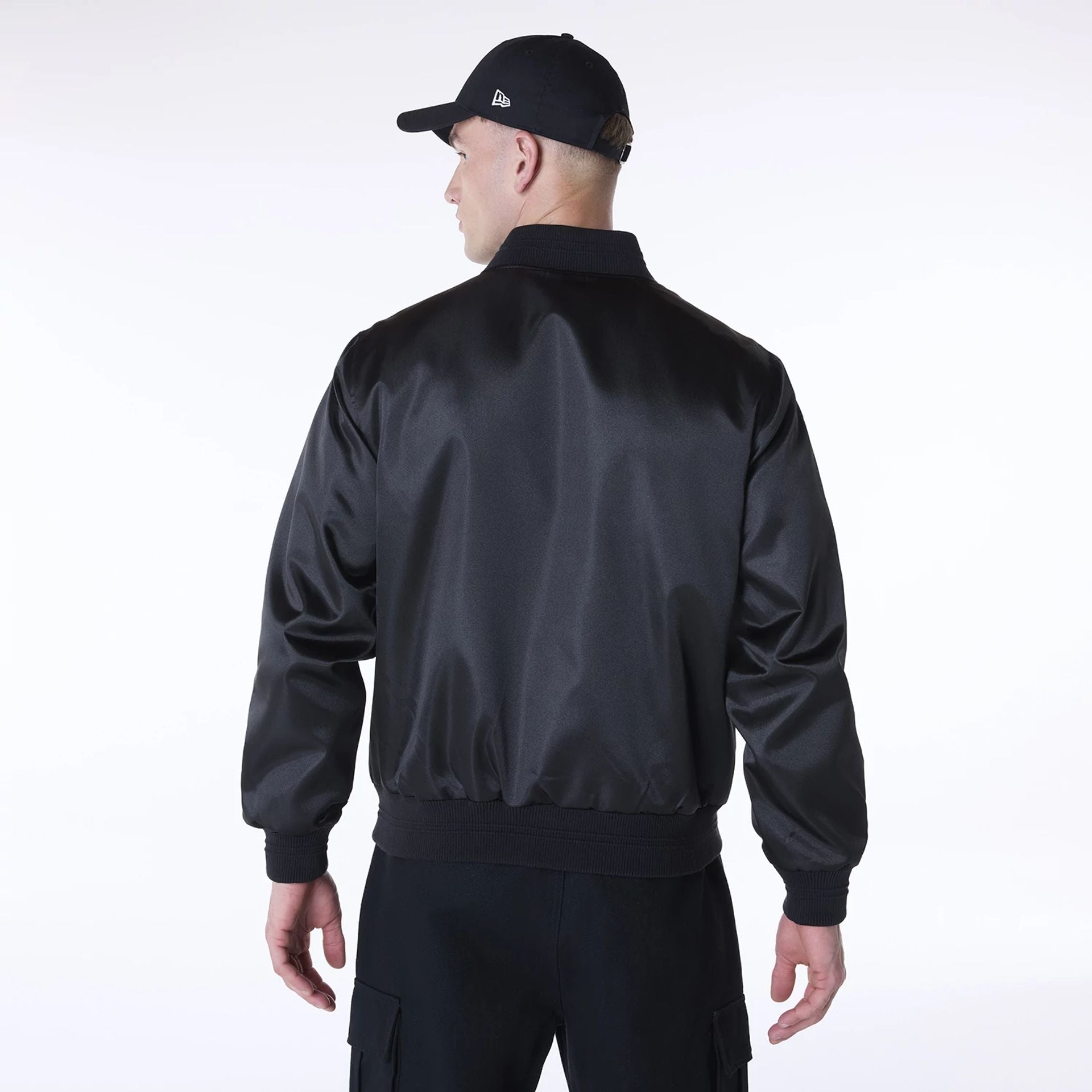 The Male model is wearing New Era Essential Black Satin Bomber Jacket 2