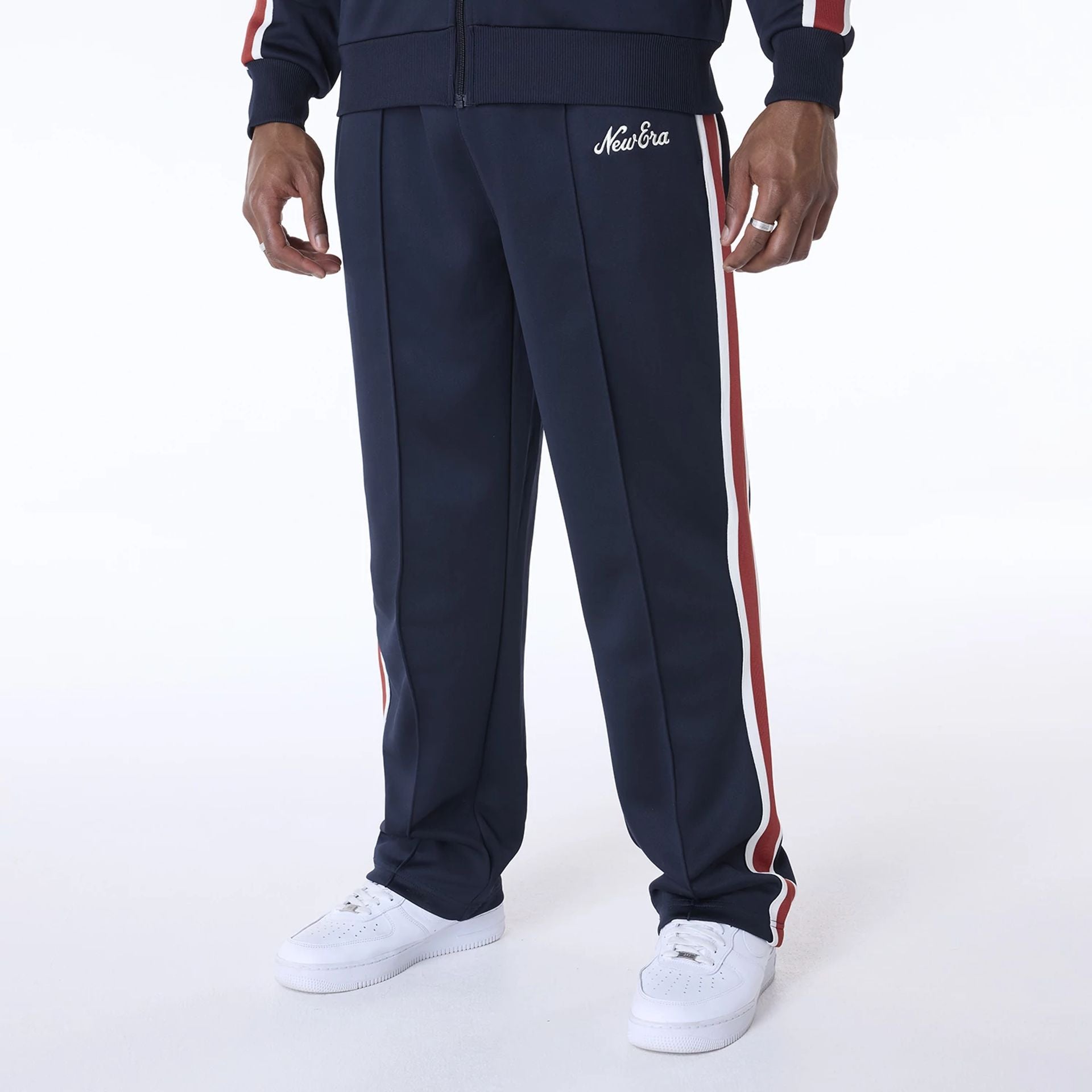 The Male model is wearing New Era Essential Navy Track Pants 1