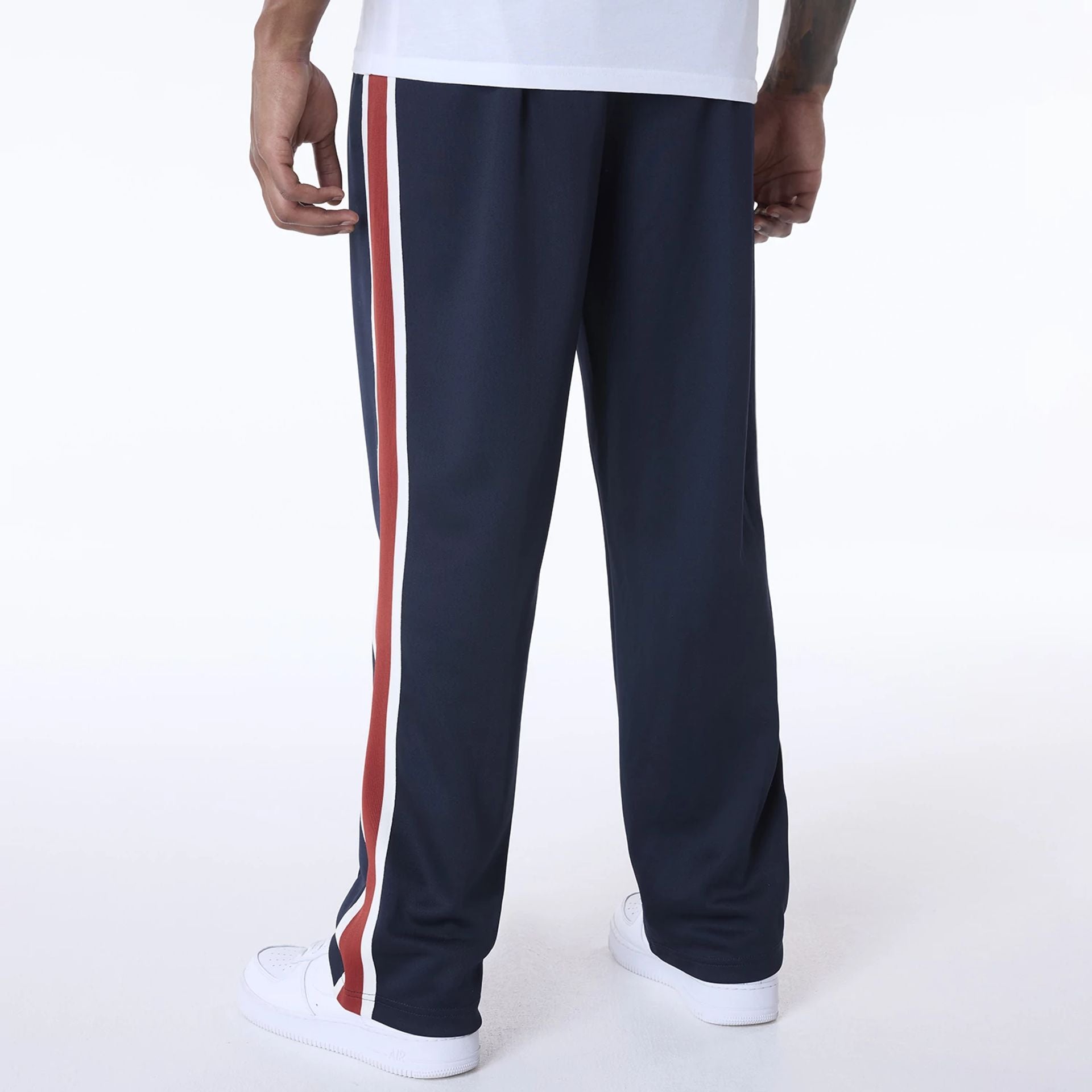 The Male model is wearing New Era Essential Navy Track Pants 2