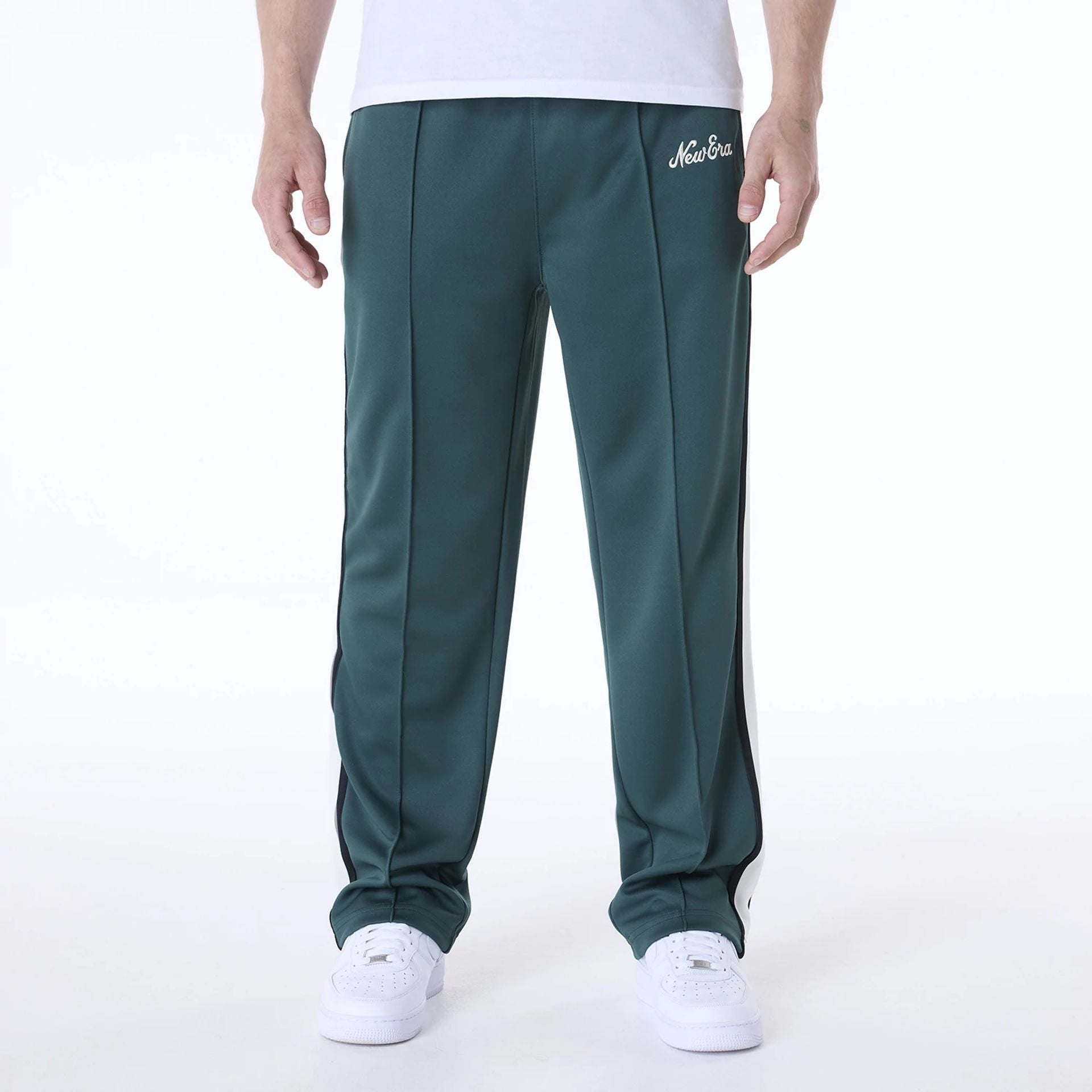 The Male model is wearing New Era Essential Dark Green Track Pants 1