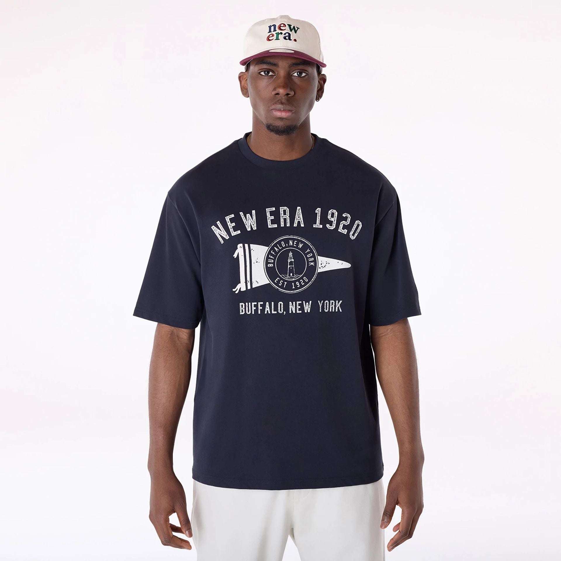 The Male model is wearing New Era Graphic Navy Oversized T-Shirt 1