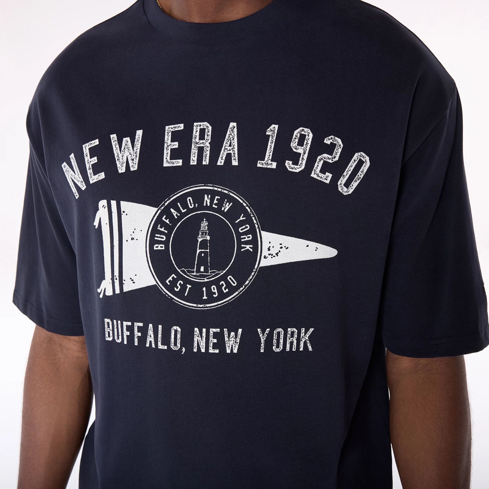 The Male model is wearing New Era Graphic Navy Oversized T-Shirt 3