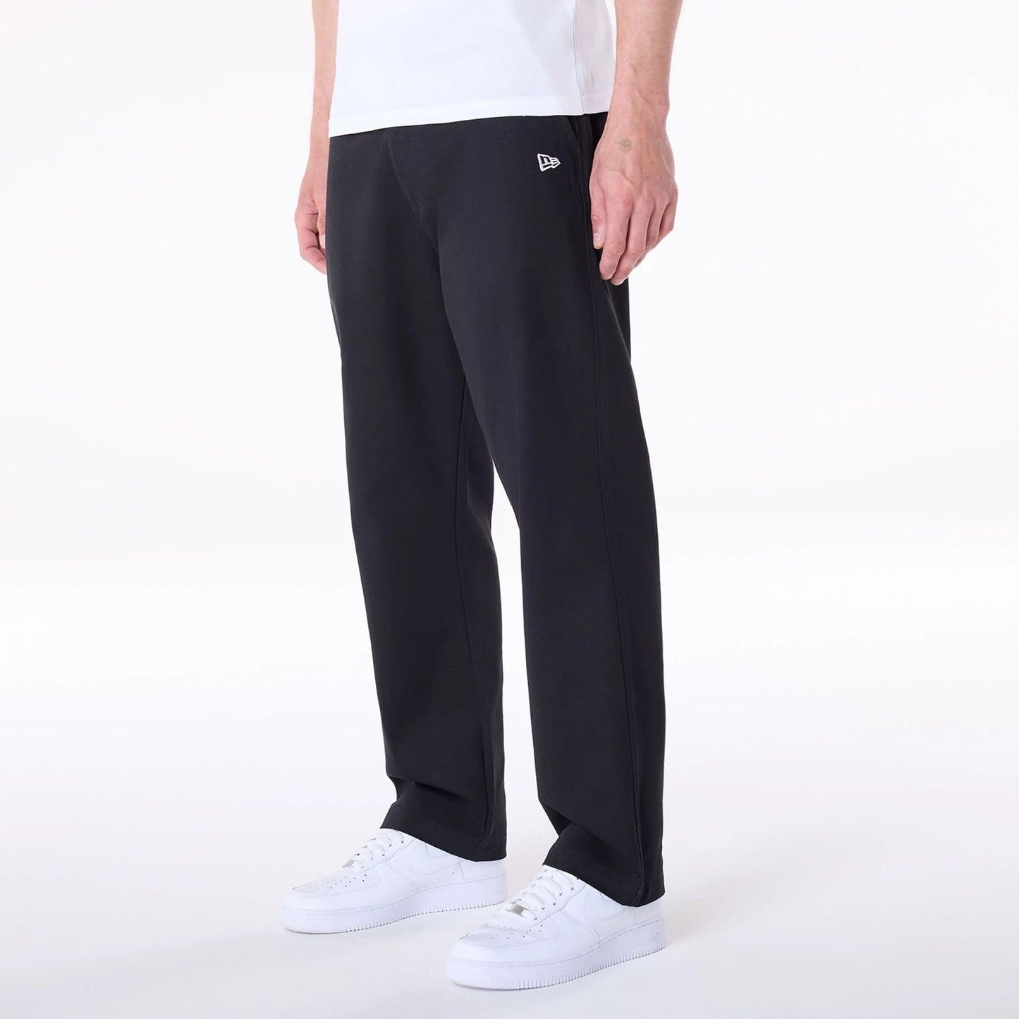 The Male model is wearing New Era Black Chino Trousers 8