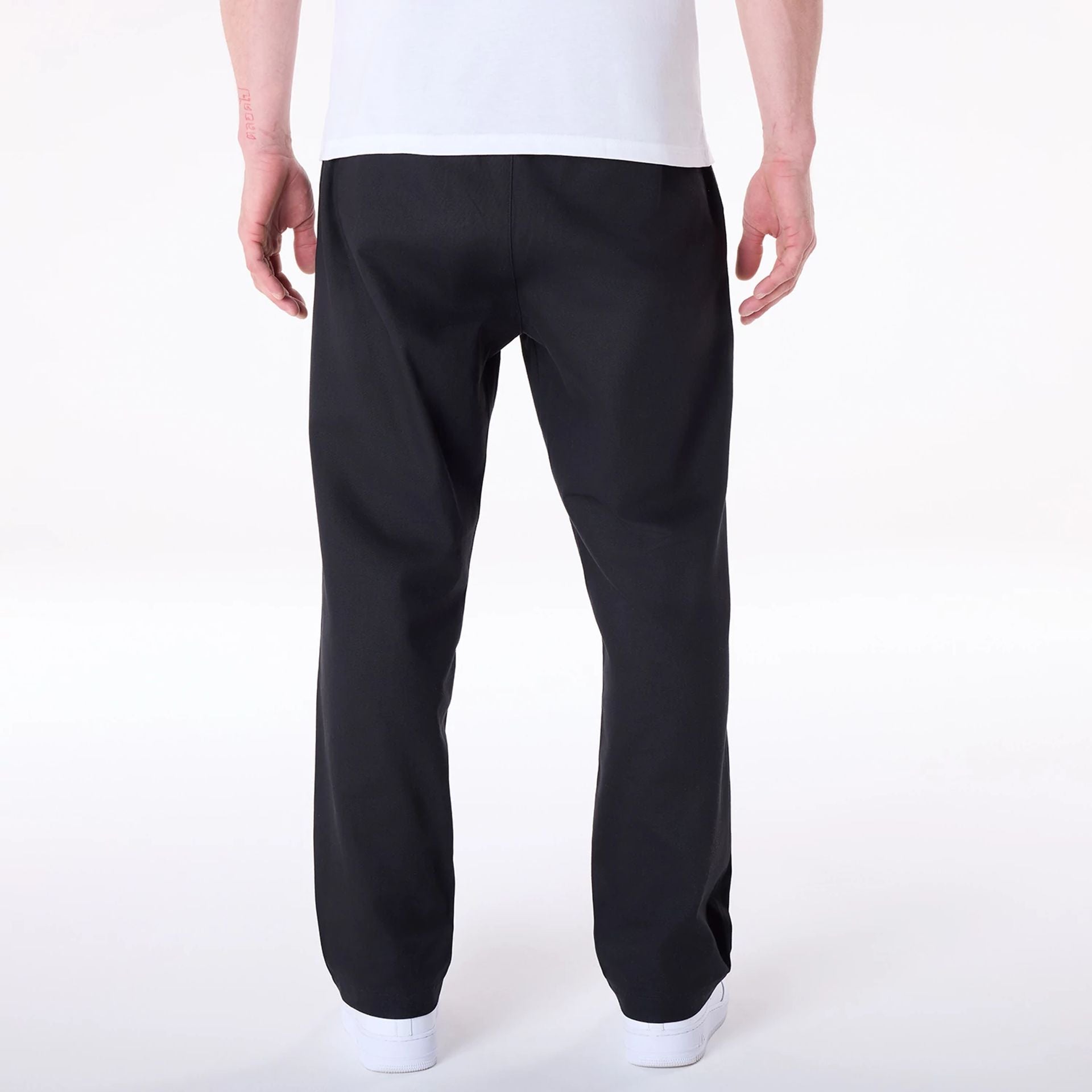 The Male model is wearing New Era Black Chino Trousers 2