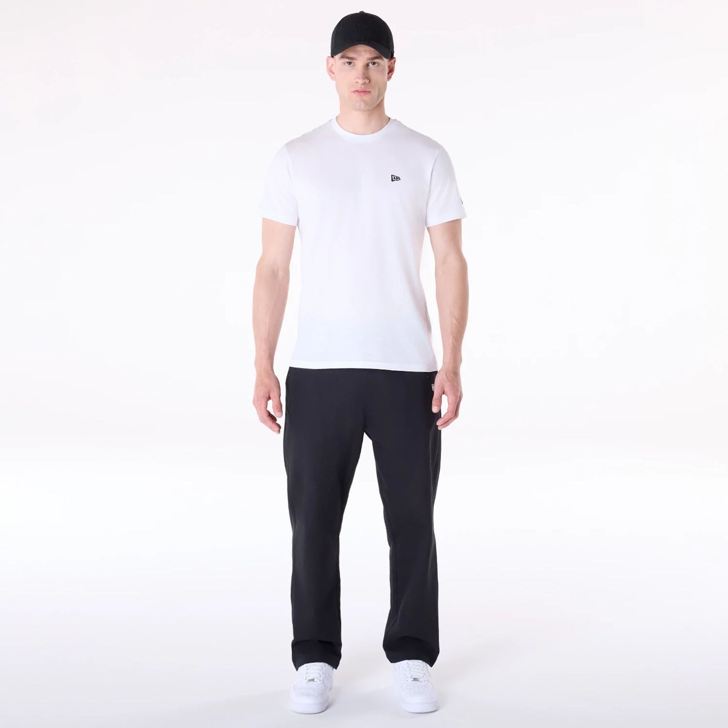 The Male model is wearing New Era Black Chino Trousers 4