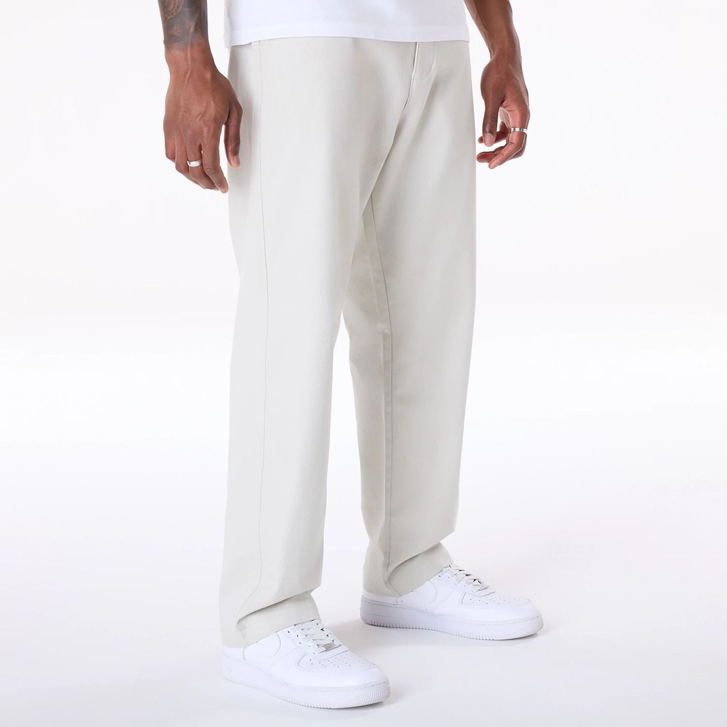 The Male model is wearing New Era Cream Chino Trousers 6