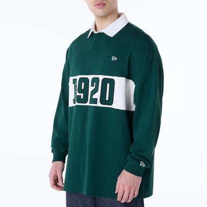 The Male model is wearing New Era Drop Shoulder Dark Green Rugby 8