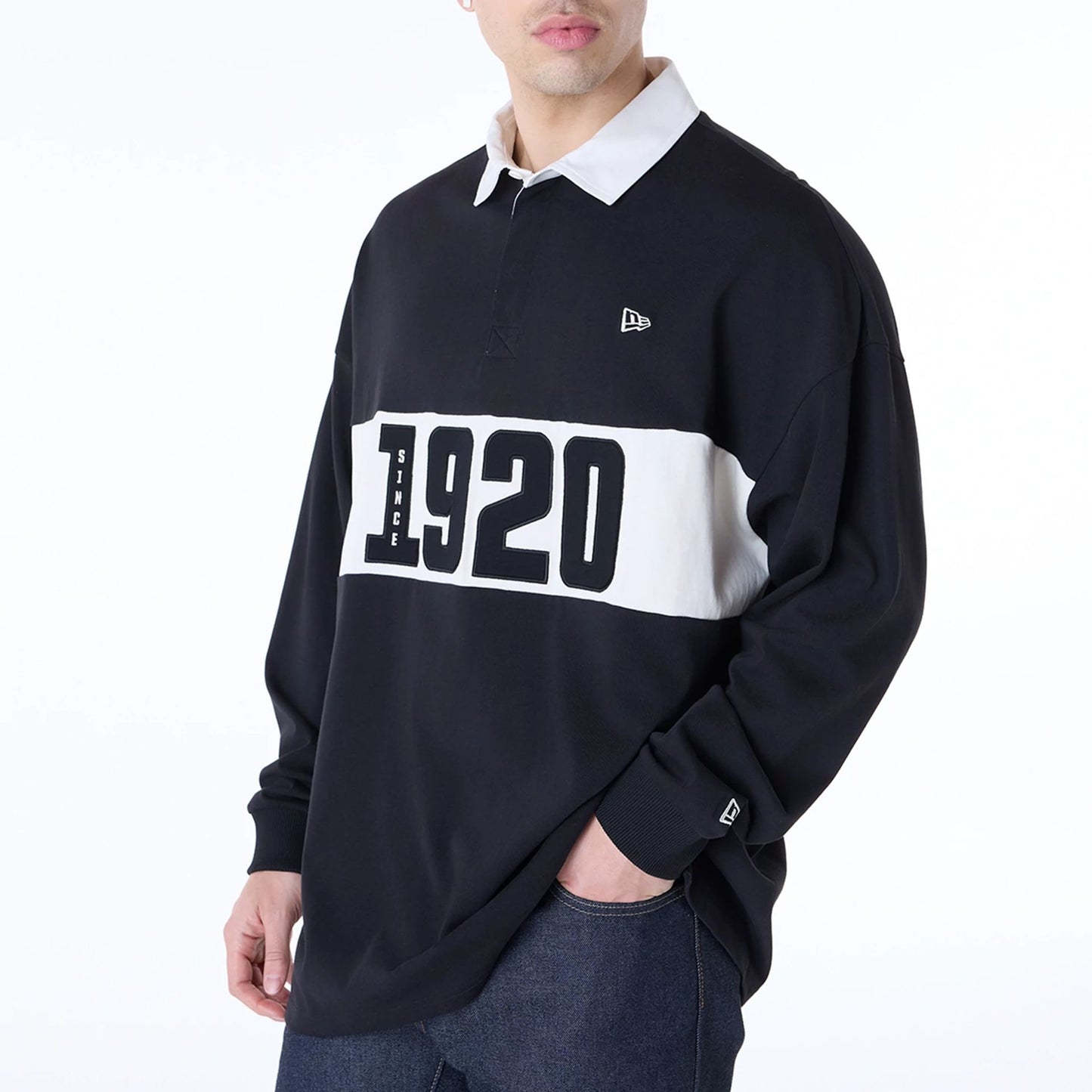 The Male model is wearing New Era Drop Shoulder Black Rugby 7