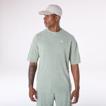 The Male model is wearing New Era Towelling Pastel Green Oversized T-Shirt 4