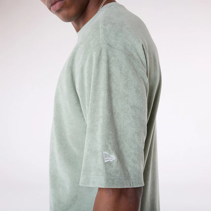 The Male model is wearing New Era Towelling Pastel Green Oversized T-Shirt 5