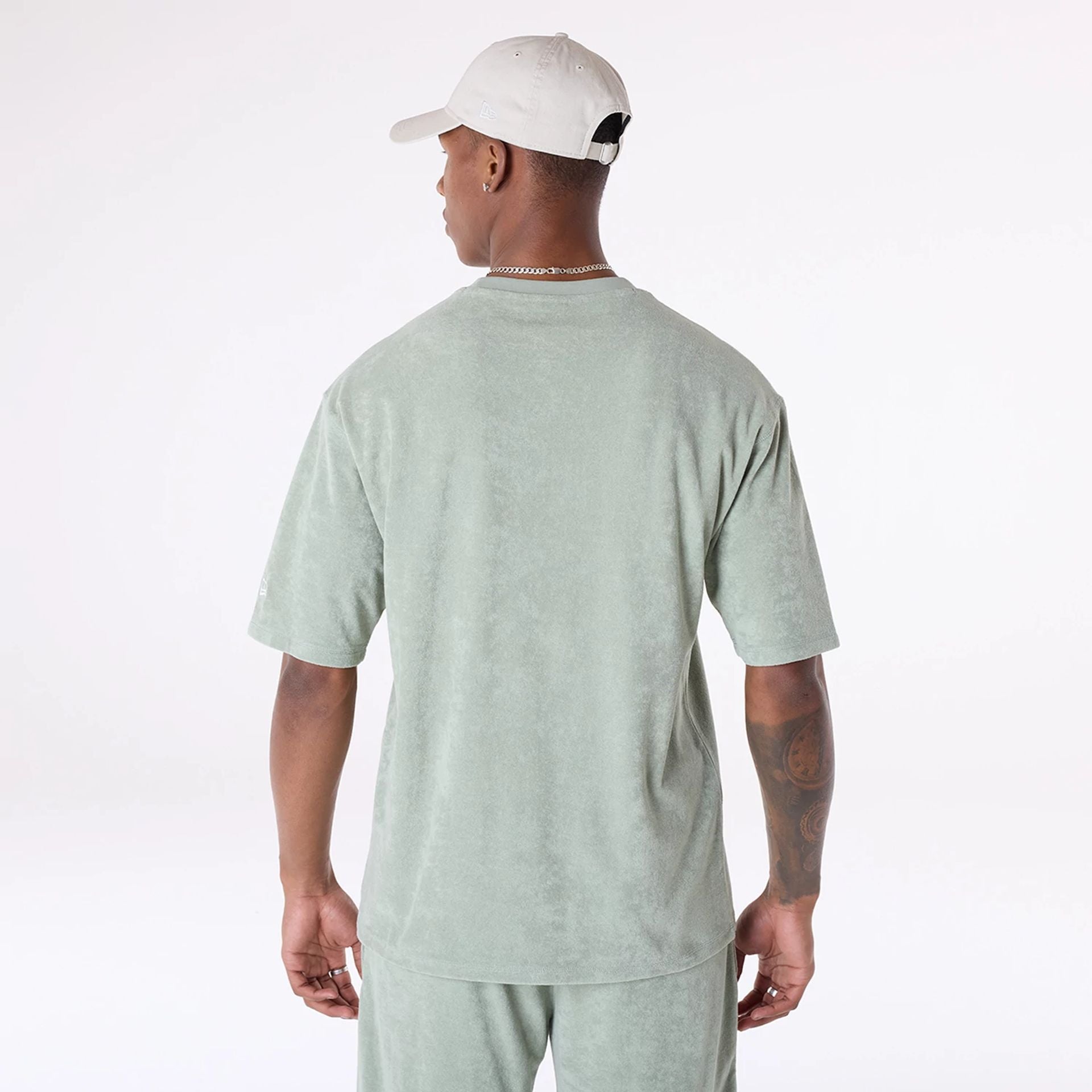 The Male model is wearing New Era Towelling Pastel Green Oversized T-Shirt 2