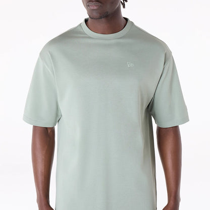 The Male model is wearing New Era Sticker Pastel Green Oversized T-Shirt 5