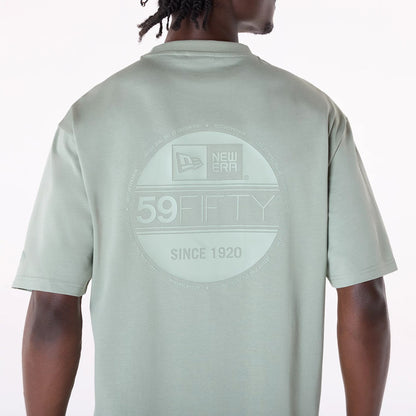 The Male model is wearing New Era Sticker Pastel Green Oversized T-Shirt 6