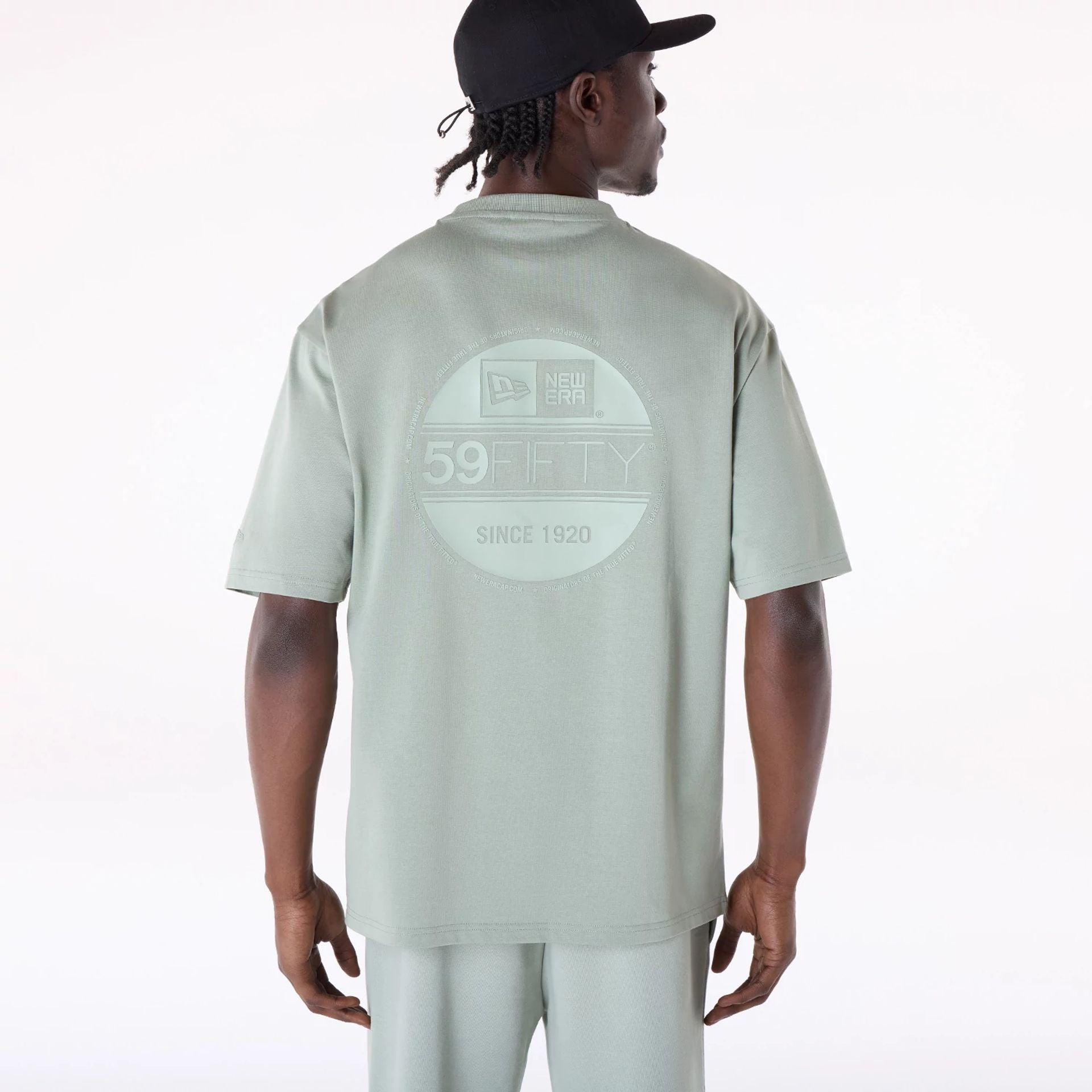 The Male model is wearing New Era Sticker Pastel Green Oversized T-Shirt 2