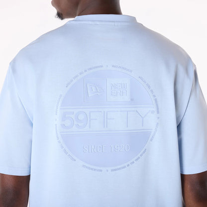 The Male model is wearing New Era Sticker Pastel Blue Oversized T-Shirt 4