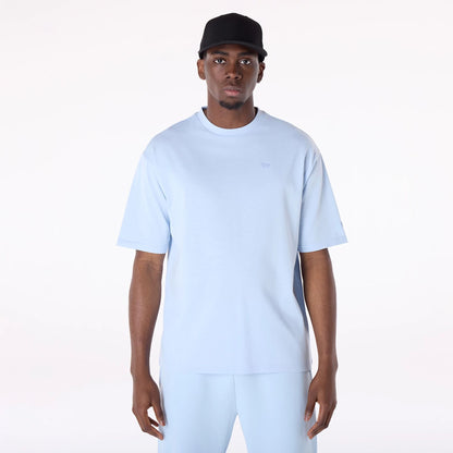 The Male model is wearing New Era Sticker Pastel Blue Oversized T-Shirt 1