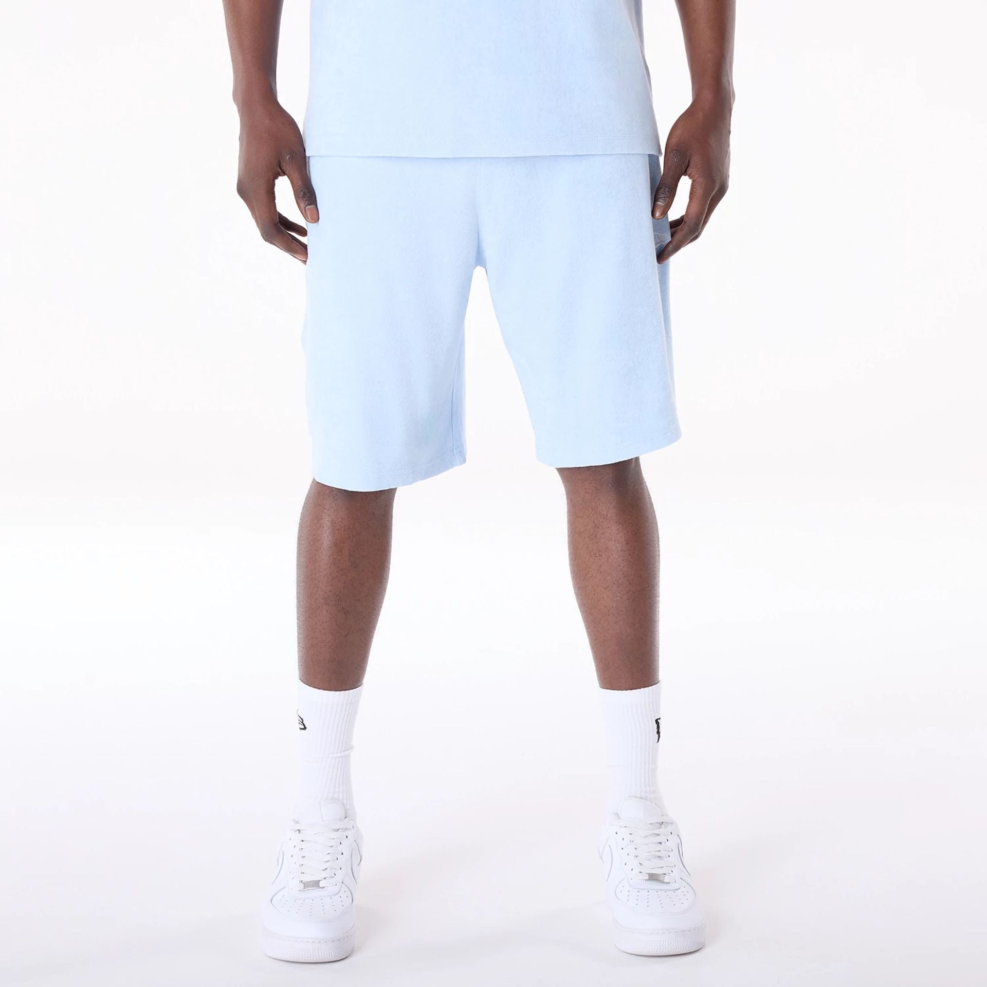 The Male model is wearing New Era Towelling Pastel Blue Shorts 1