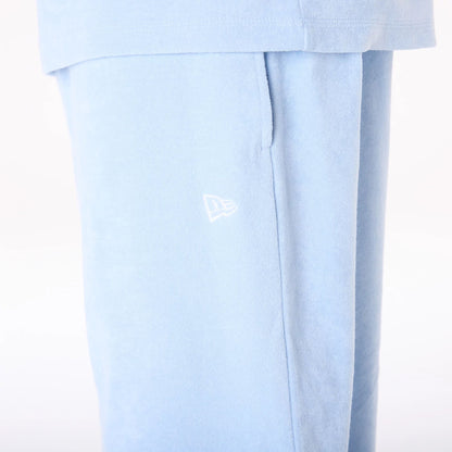 The Male model is wearing New Era Towelling Pastel Blue Shorts 5