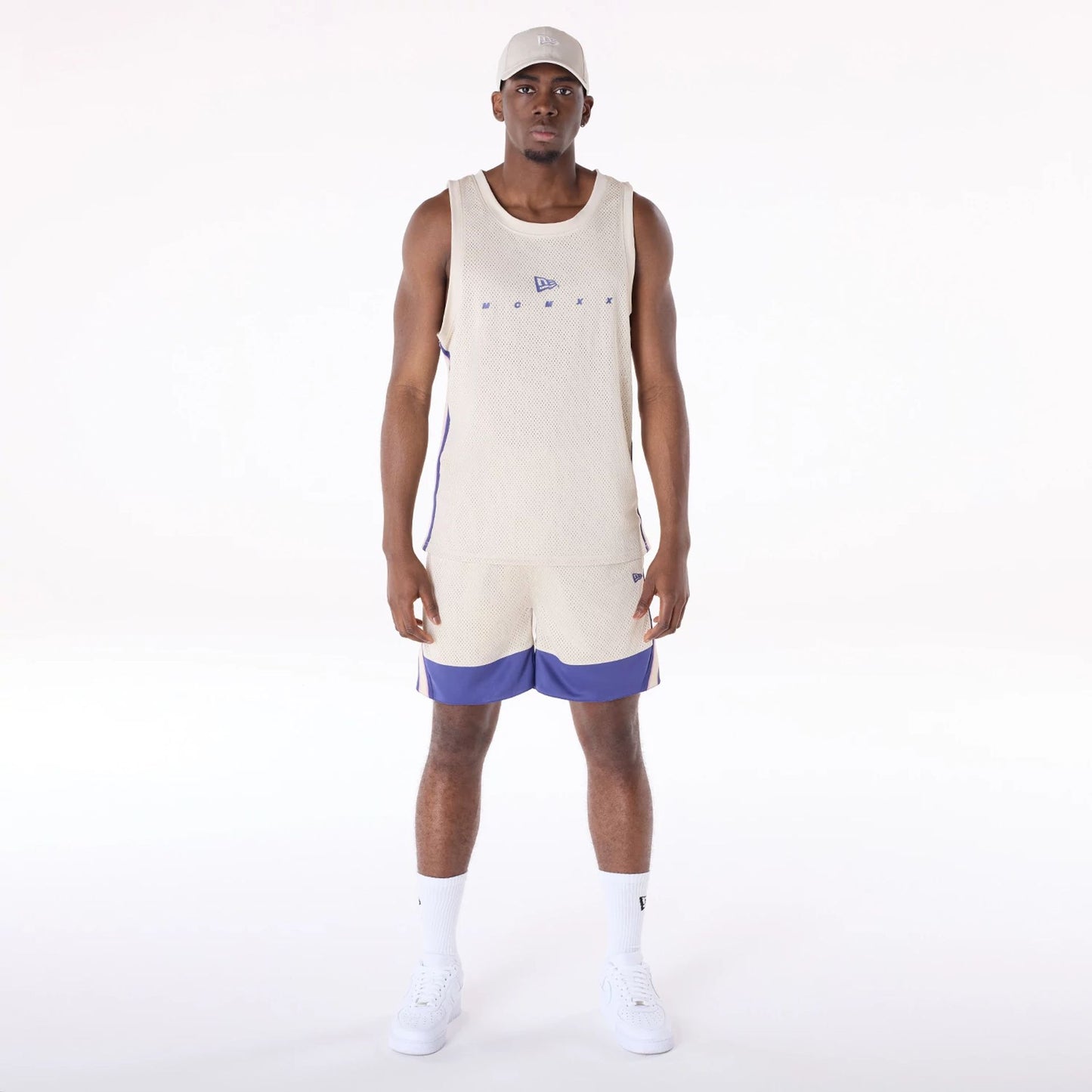 The Male model is wearing New Era Mesh Light Beige Oversized Shorts 8