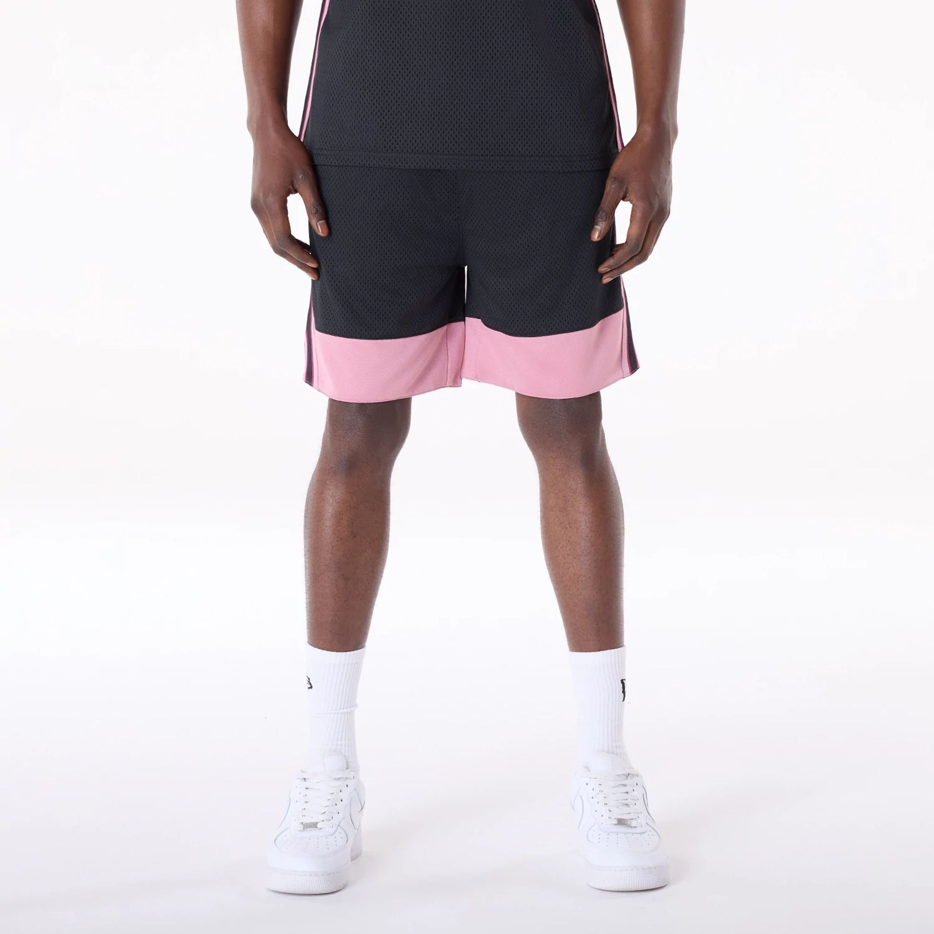 The Male model is wearing New Era Mesh Black Oversized Shorts 1