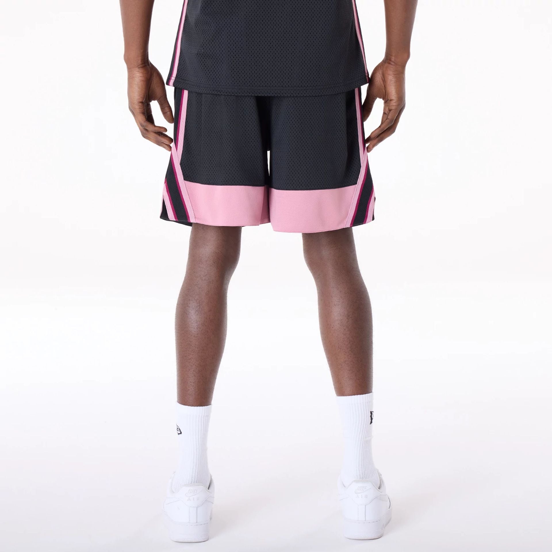 The Male model is wearing New Era Mesh Black Oversized Shorts 2