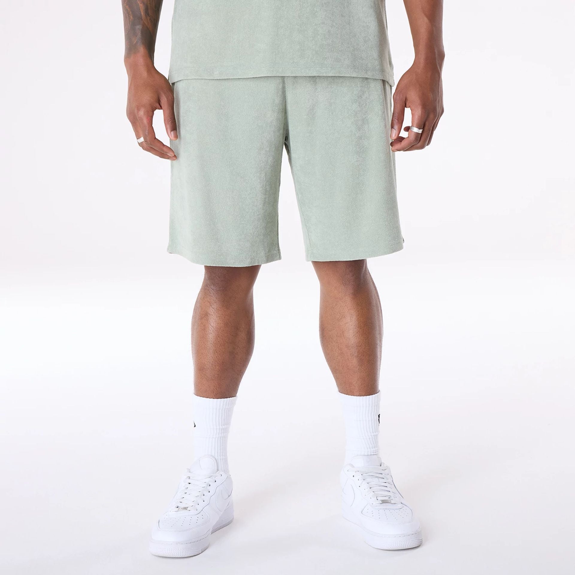 The Male model is wearing New Era Towelling Pastel Green Shorts 1