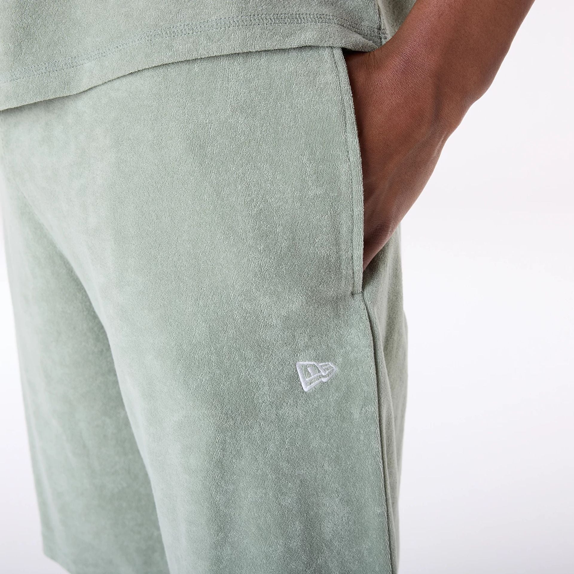 The Male model is wearing New Era Towelling Pastel Green Shorts 4