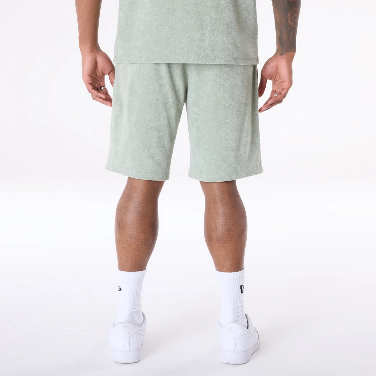 The Male model is wearing New Era Towelling Pastel Green Shorts 2