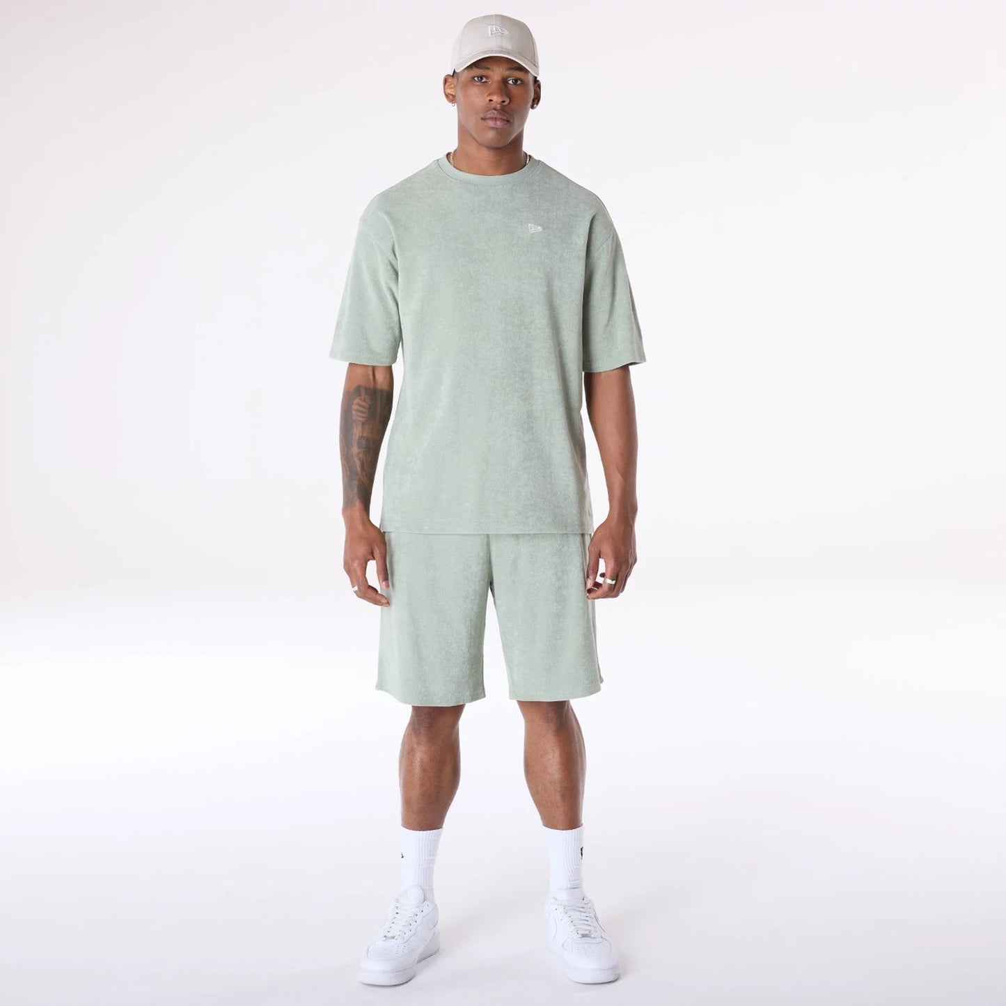 The Male model is wearing New Era Towelling Pastel Green Shorts 3