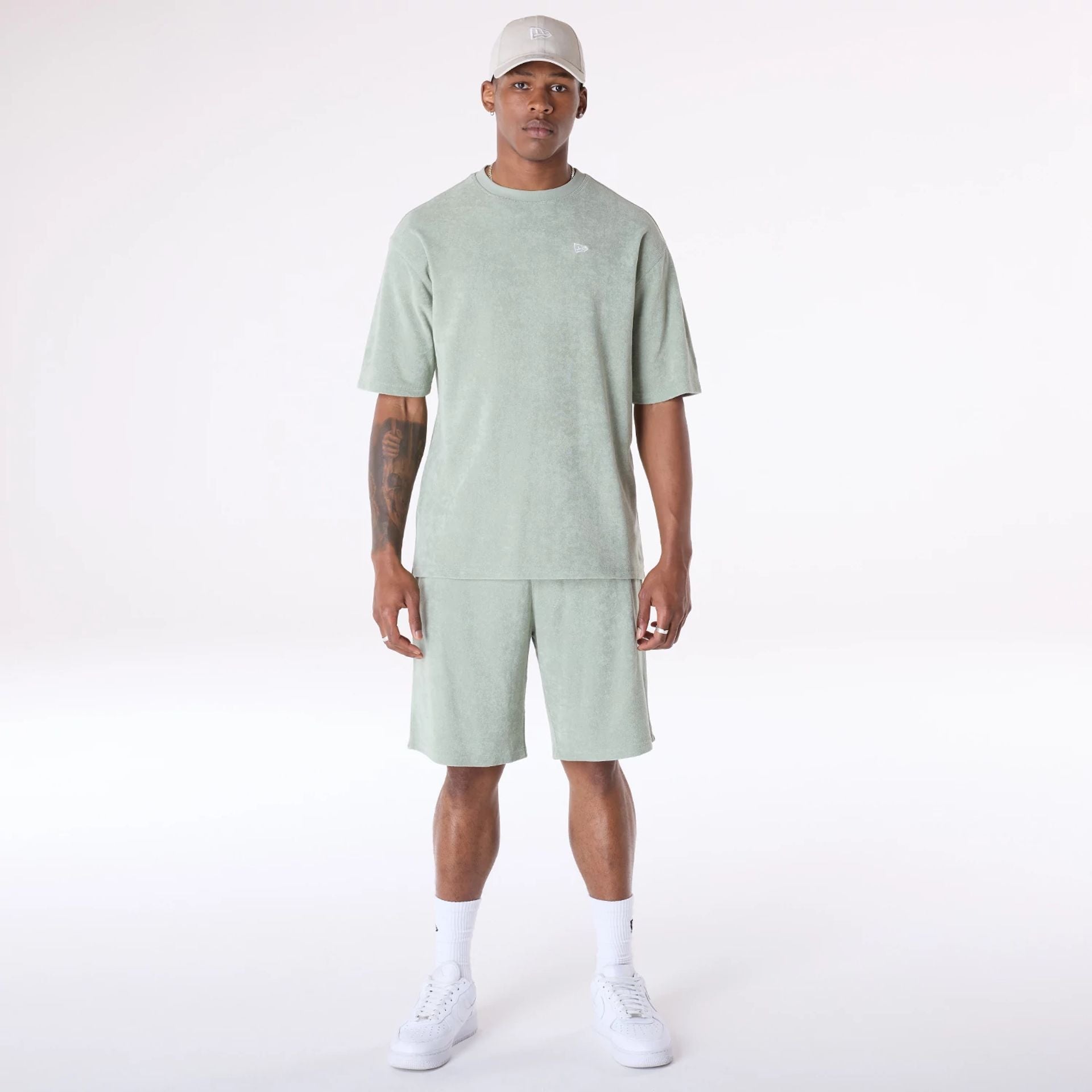 The Male model is wearing New Era Towelling Pastel Green Shorts 3