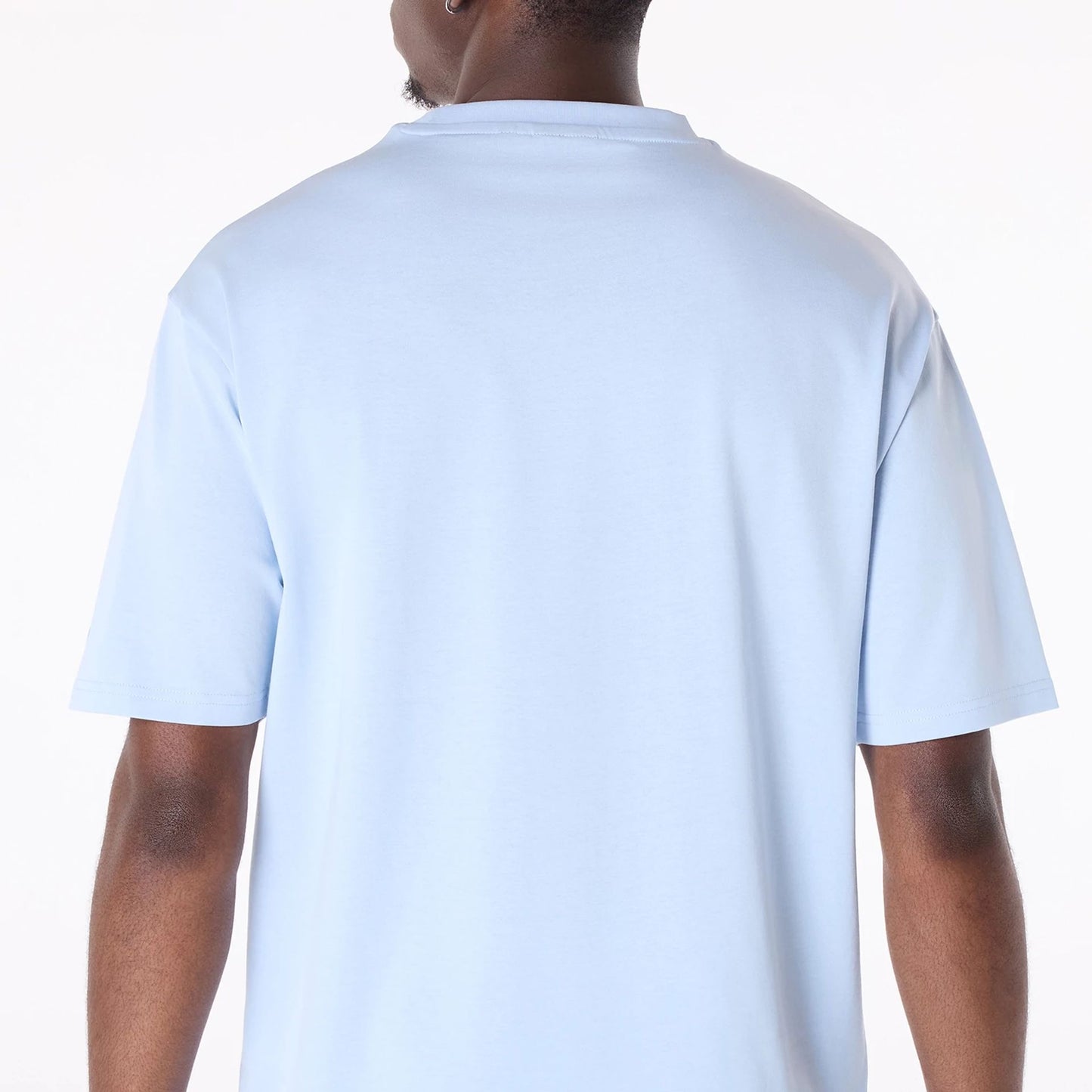 The Male model is wearing New Era Flag Pastel Blue Oversized T-Shirt 4