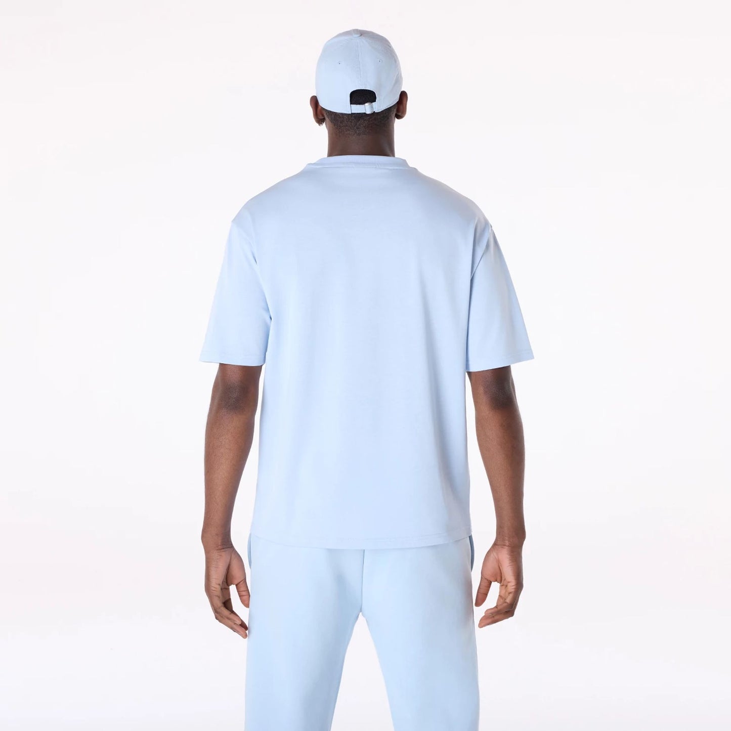 The Male model is wearing New Era Flag Pastel Blue Oversized T-Shirt 2